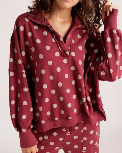 Burgundy polka dot pullover sweatshirt with snap placket and balloon sleeves