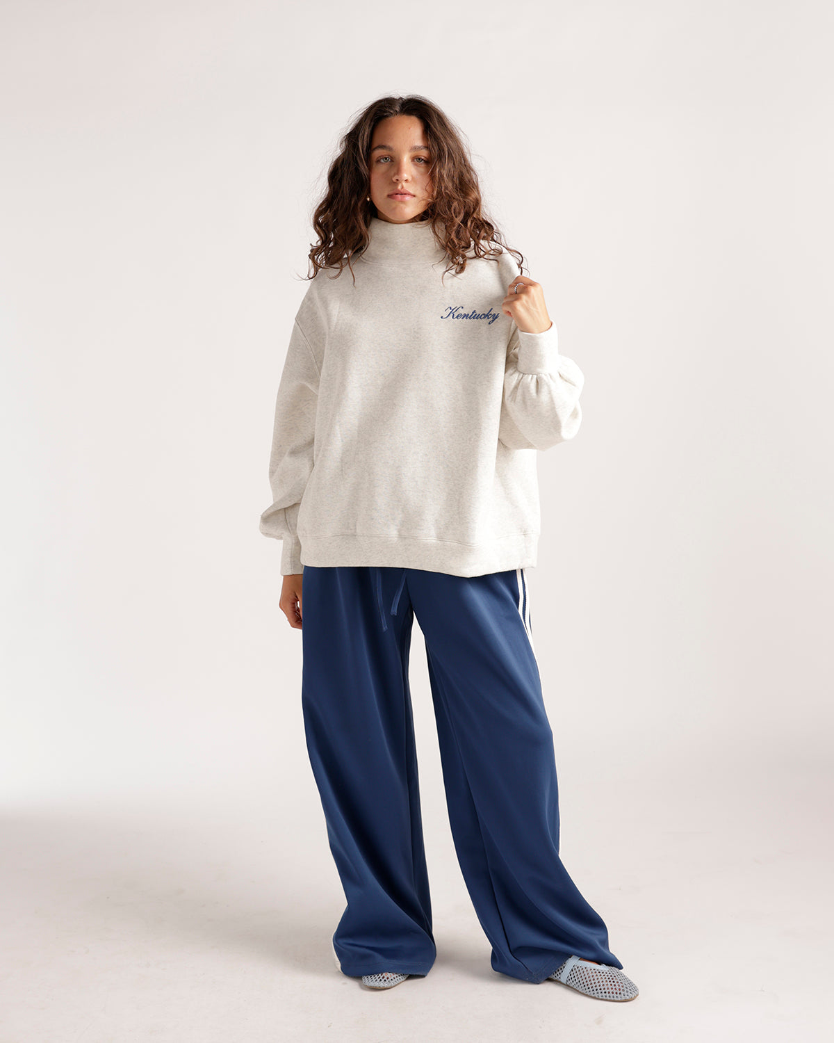 Oatmeal mock neck sweatshirt with cursive Kentucky embroidery on chest