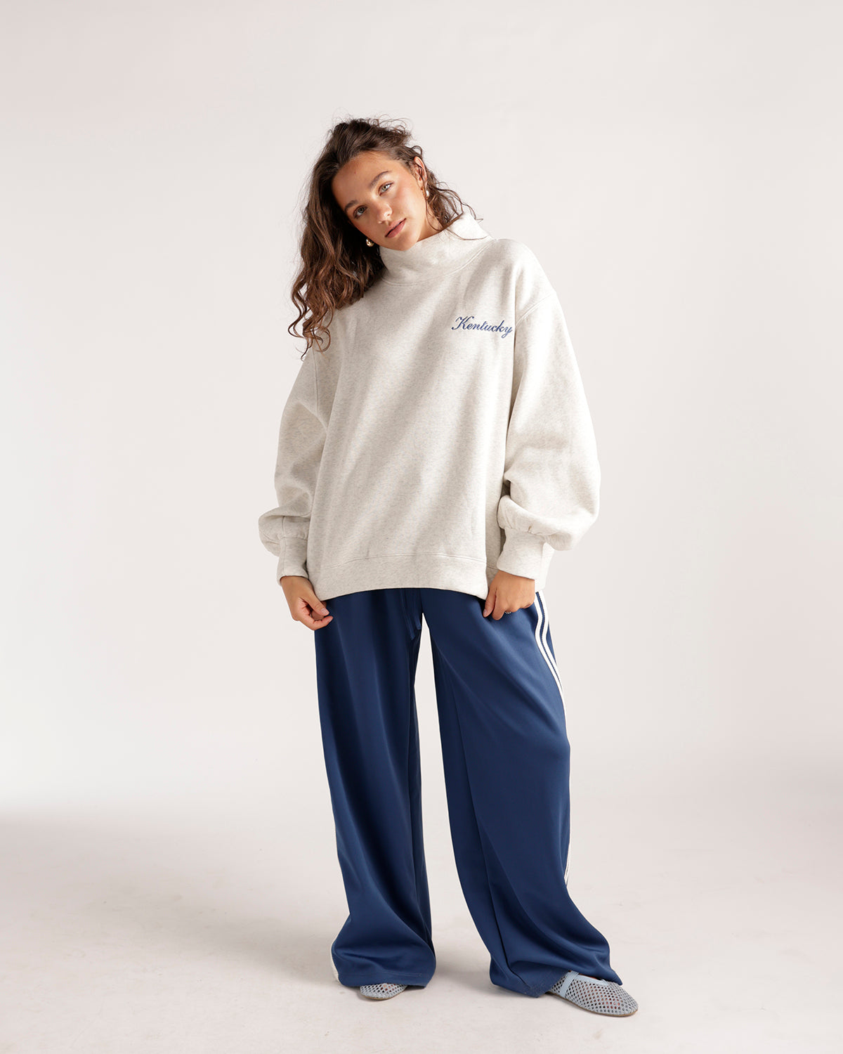 Oversized cream mock neck sweatshirt with blue Kentucky script embroidery on chest