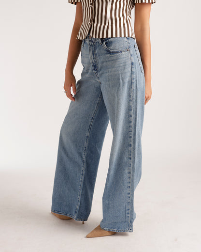 Wide leg light wash blue denim jeans with high rise and straight cut