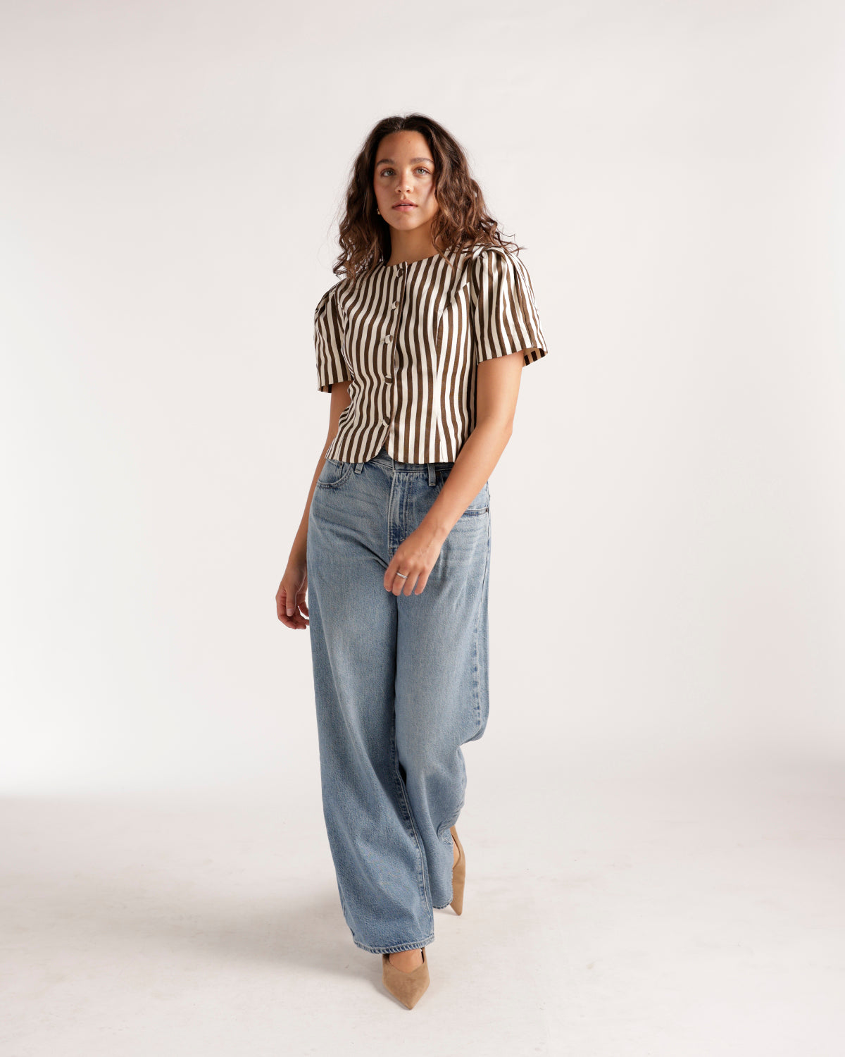 Light wash wide leg jeans styled with a striped short sleeve top and nude heels.