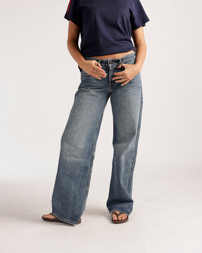 Wide-leg low-rise medium wash blue denim jeans with relaxed fit and slight fade