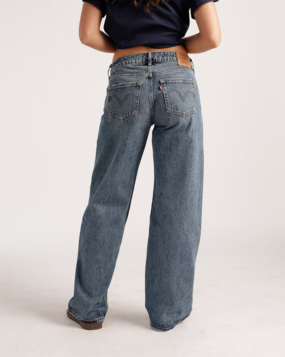 Women's wide-leg medium blue wash denim jeans, back view, low rise fit
