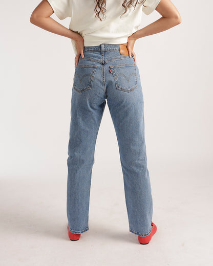 Back view of light blue straight-leg jeans with classic back pockets and gold stitching
