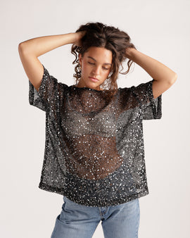 Black sheer sequin mesh short-sleeve oversized top paired with light wash jeans