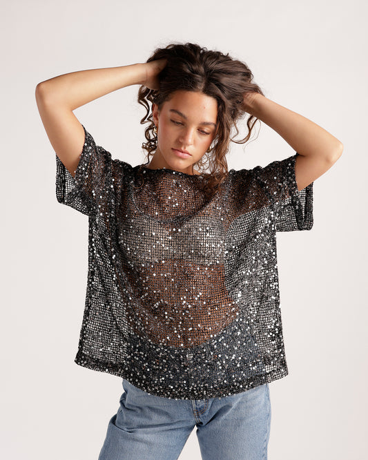 Black sheer sequin mesh short-sleeve oversized top paired with light wash jeans