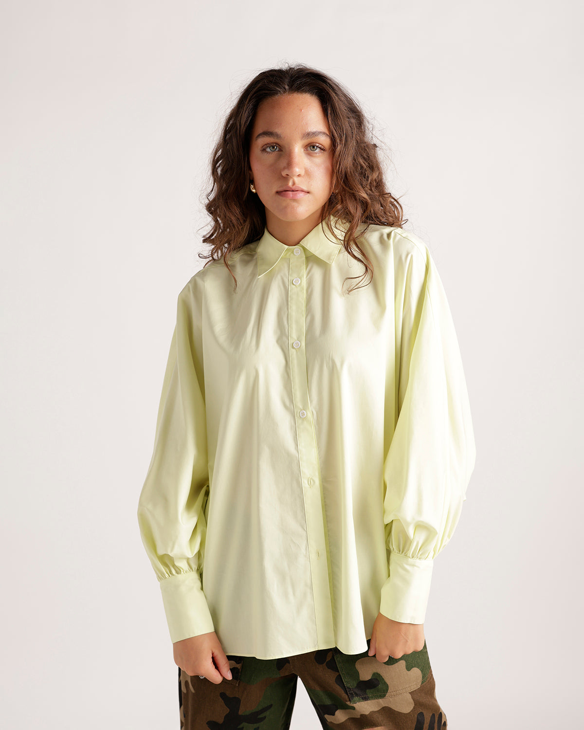 Pale yellow long sleeve button-up shirt with puff sleeves and cuffed wrists