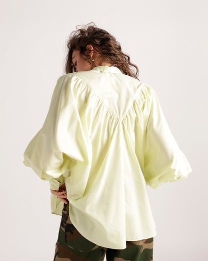Pale yellow oversized button-up shirt with balloon sleeves and gathered back detail