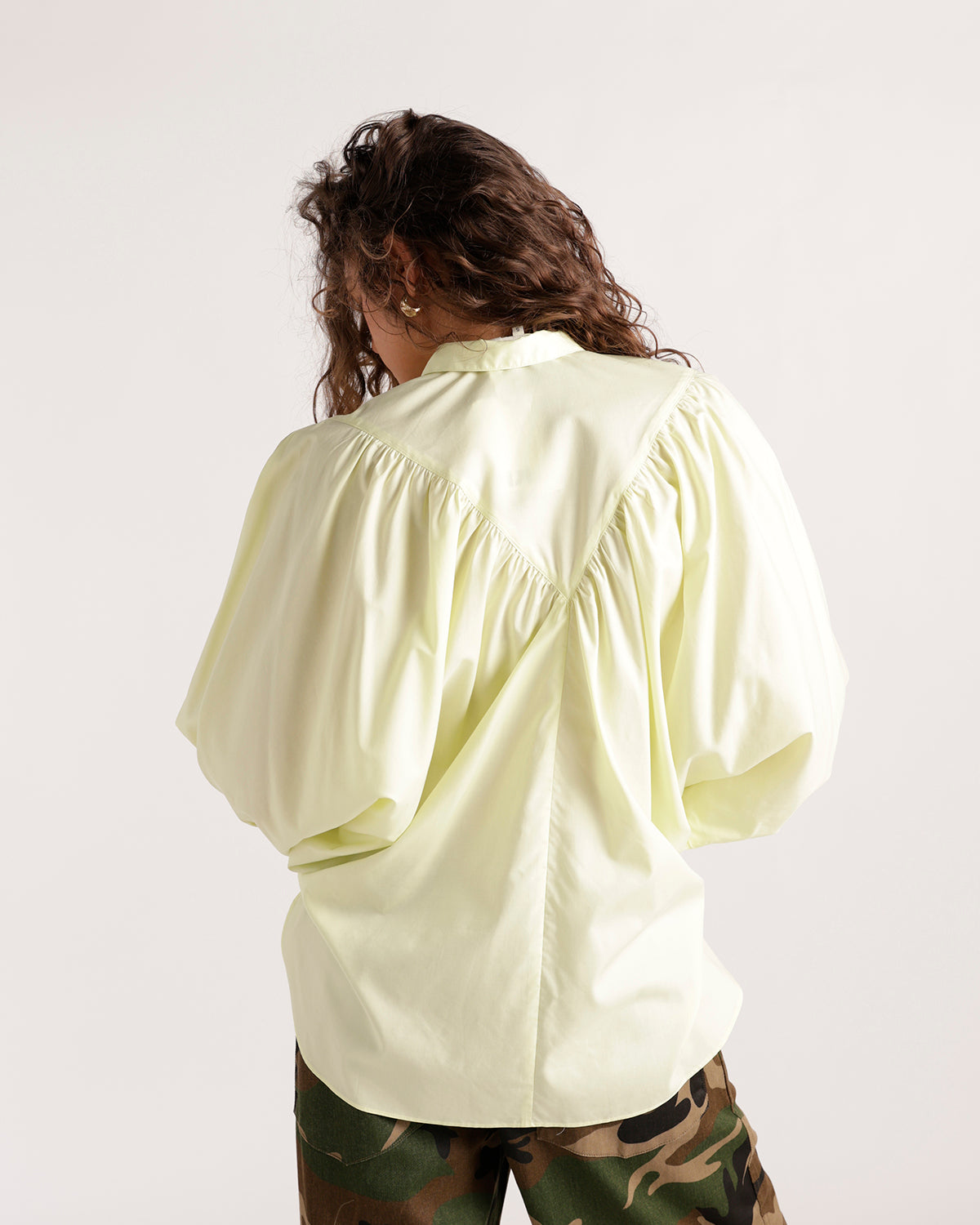Light yellow oversized button-up shirt with balloon sleeves and gathered back detail.