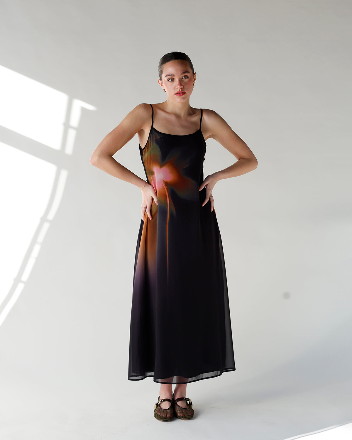 black slip dress with colored gradient floral design