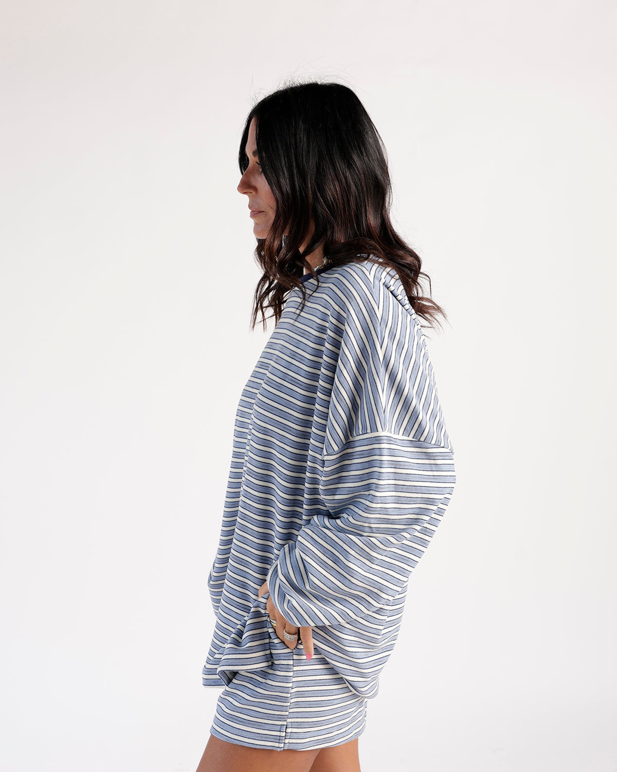 Blue and white striped shorts with matching oversized long-sleeve top, side view