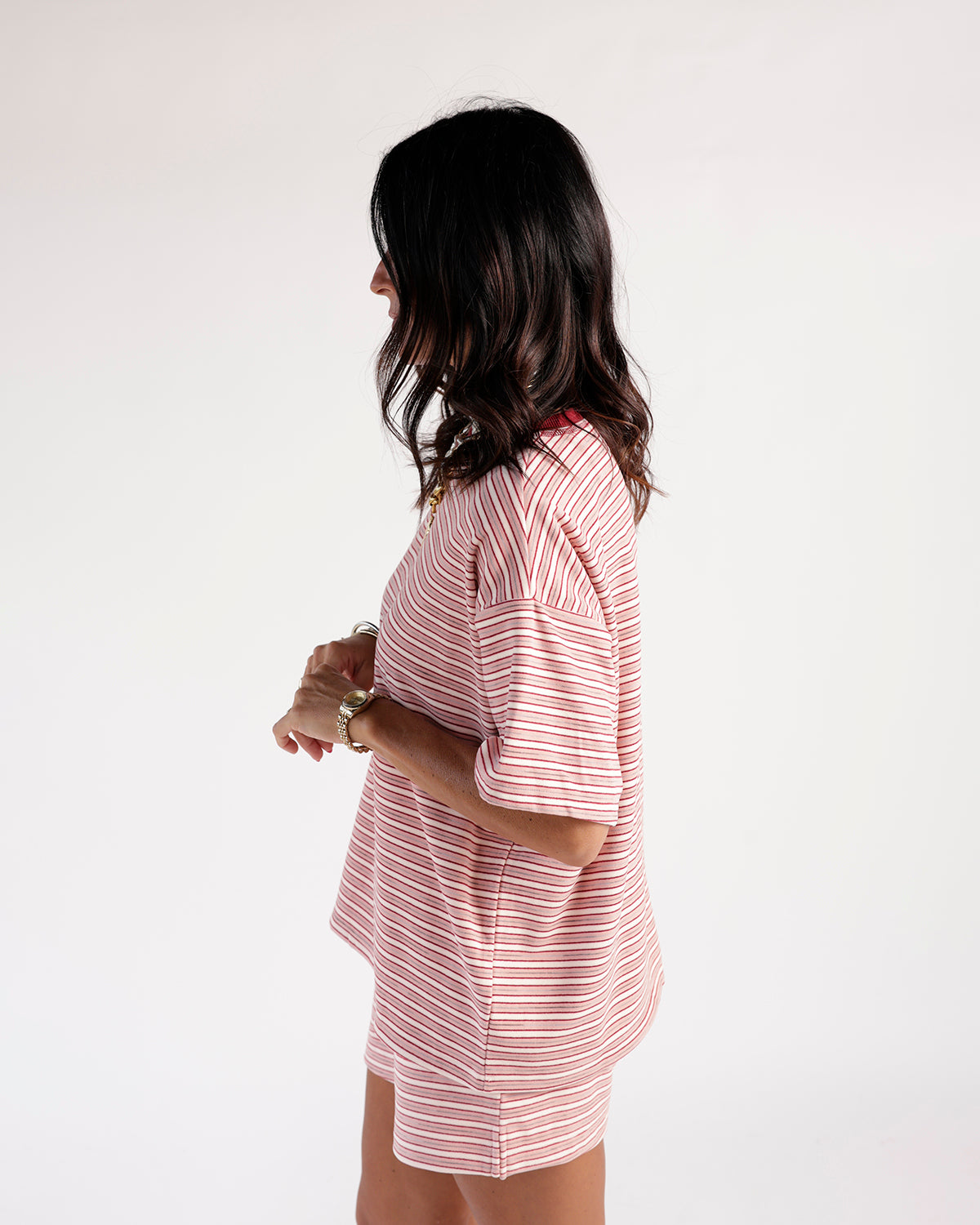 Red and white striped short sleeve oversized tee, side view on model
