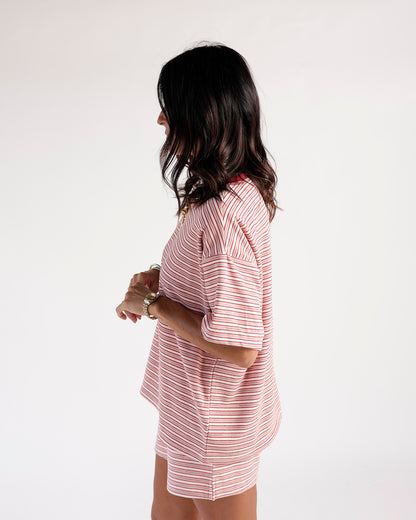 Red and white striped short sleeve oversized tee, side view on model