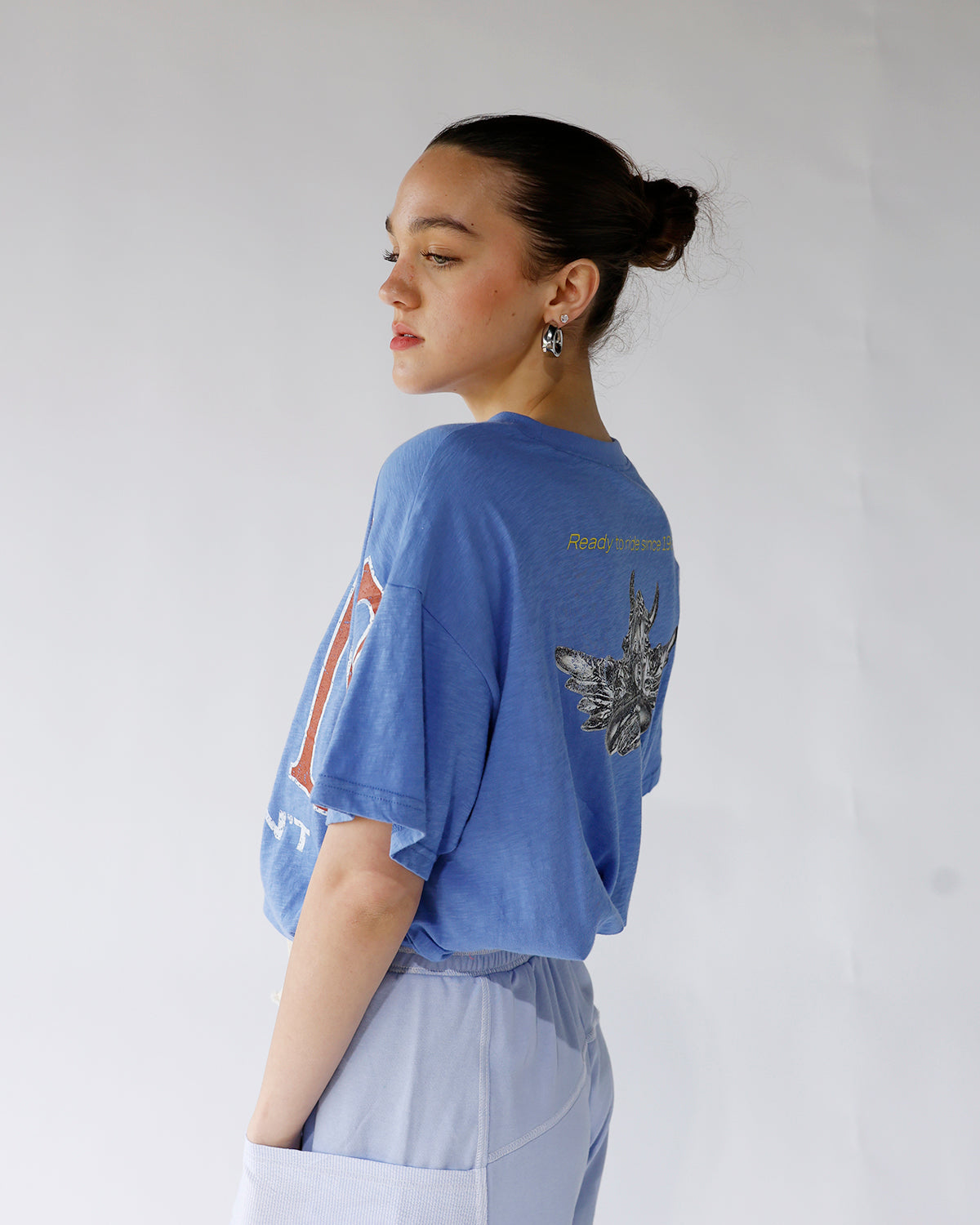 Oversized blue graphic crop tee with back print, worn with light blue joggers