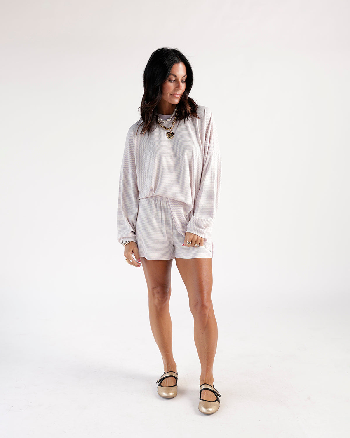 Lilac striped shorts with elastic waist, worn with matching long-sleeve top.