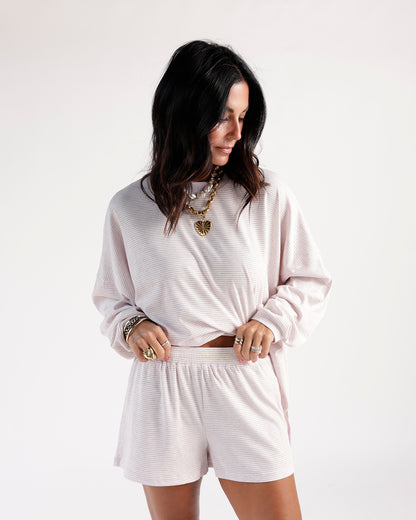 Lilac striped casual shorts with elastic waistband, paired with matching long-sleeve top.