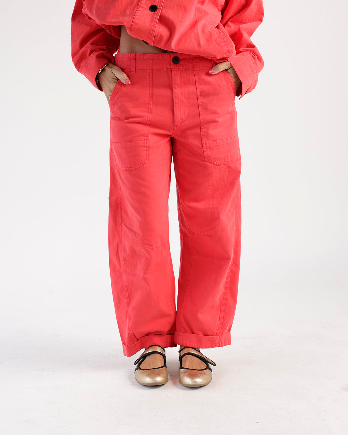 Red wide-leg utility pants with front patch pockets and cuffed hem