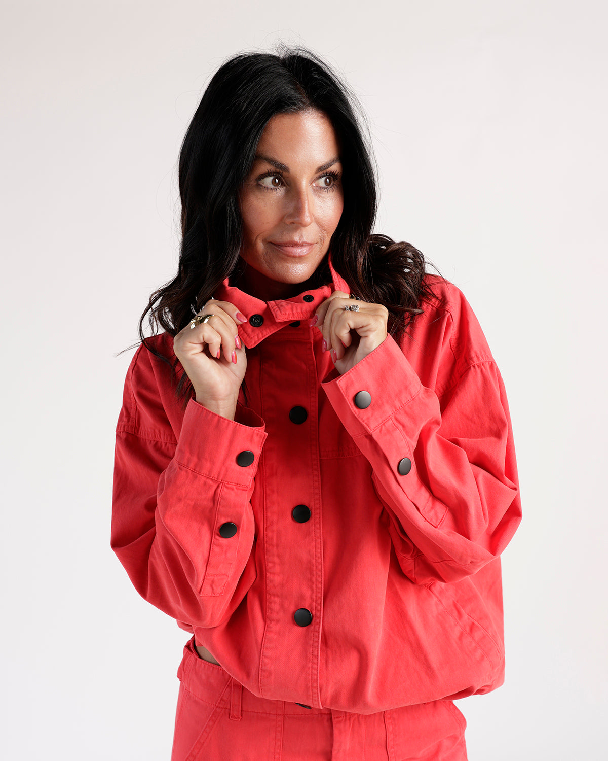 Cropped red jacket with black snap buttons and funnel neck collar