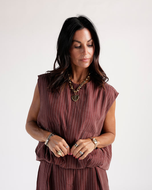 Sleeveless mulberry striped cargo vest with zip detail, styled with gold jewelry