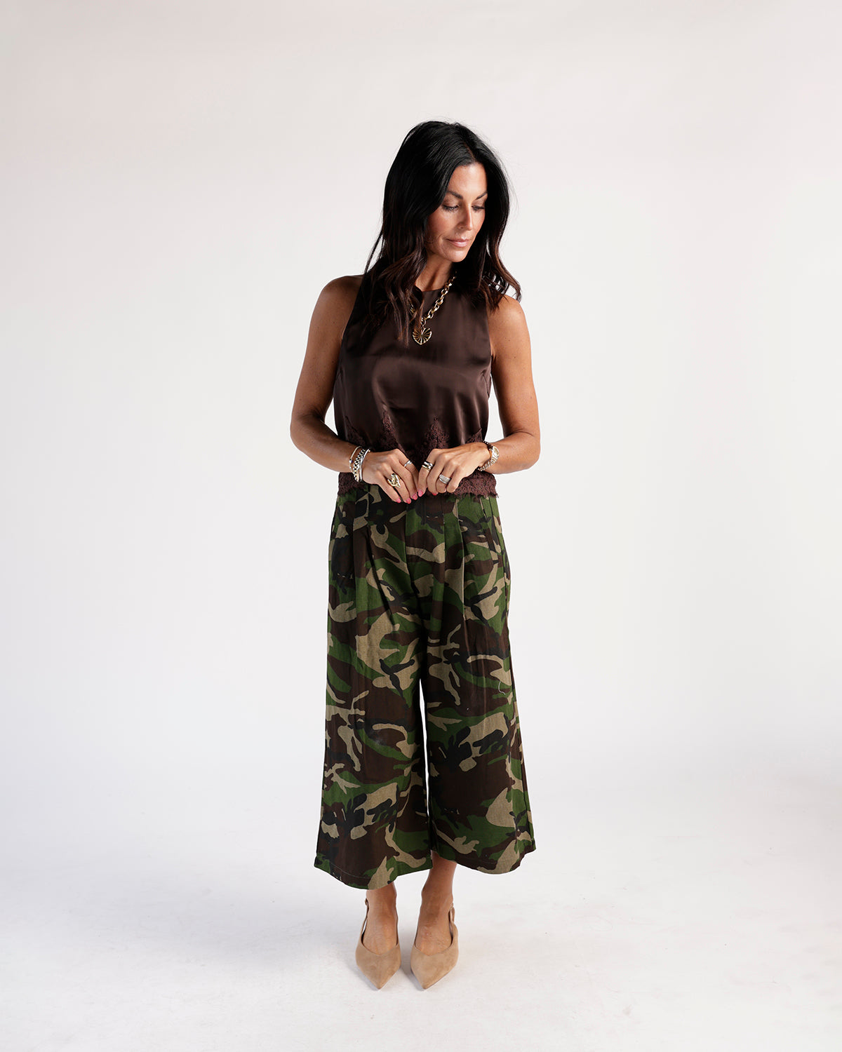 Sleeveless brown satin lace-hem top styled with wide-leg camo culottes