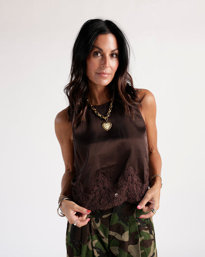 Discover the versatile Autumn Whispers Top, perfect for layering. Features a classic round neckline & delicate lace hem in a rich brown hue.
