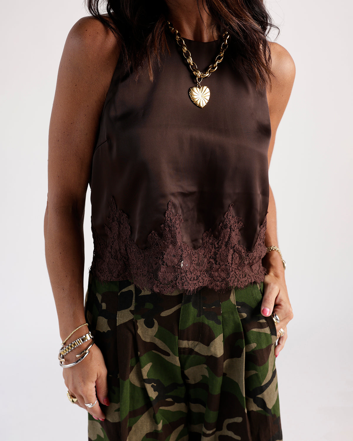 Chocolate brown satin sleeveless top with lace hem trim, worn with camo skirt