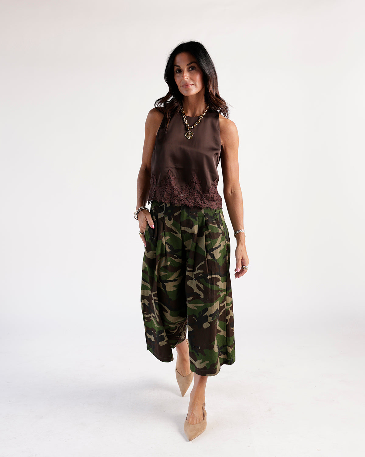Sleeveless dark brown satin lace-hem top styled with camo wide-leg pants