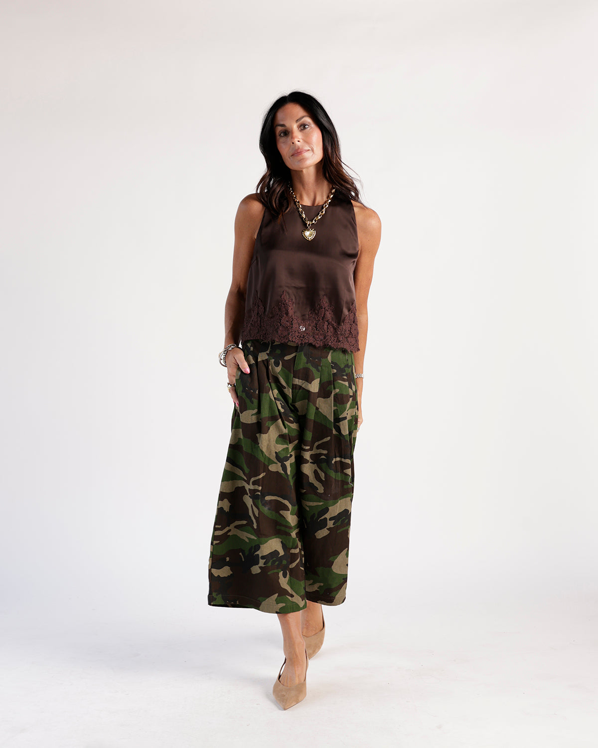 Wide-leg camouflage cropped pants in green and brown worn with a brown satin top