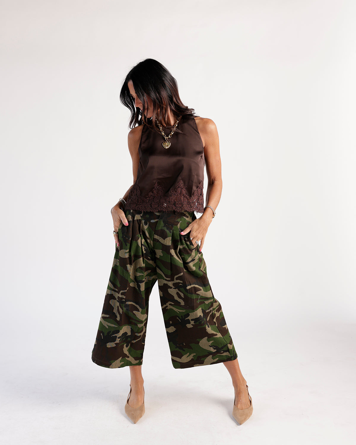 Wide-leg camouflage cropped pants in green and brown worn with brown satin top