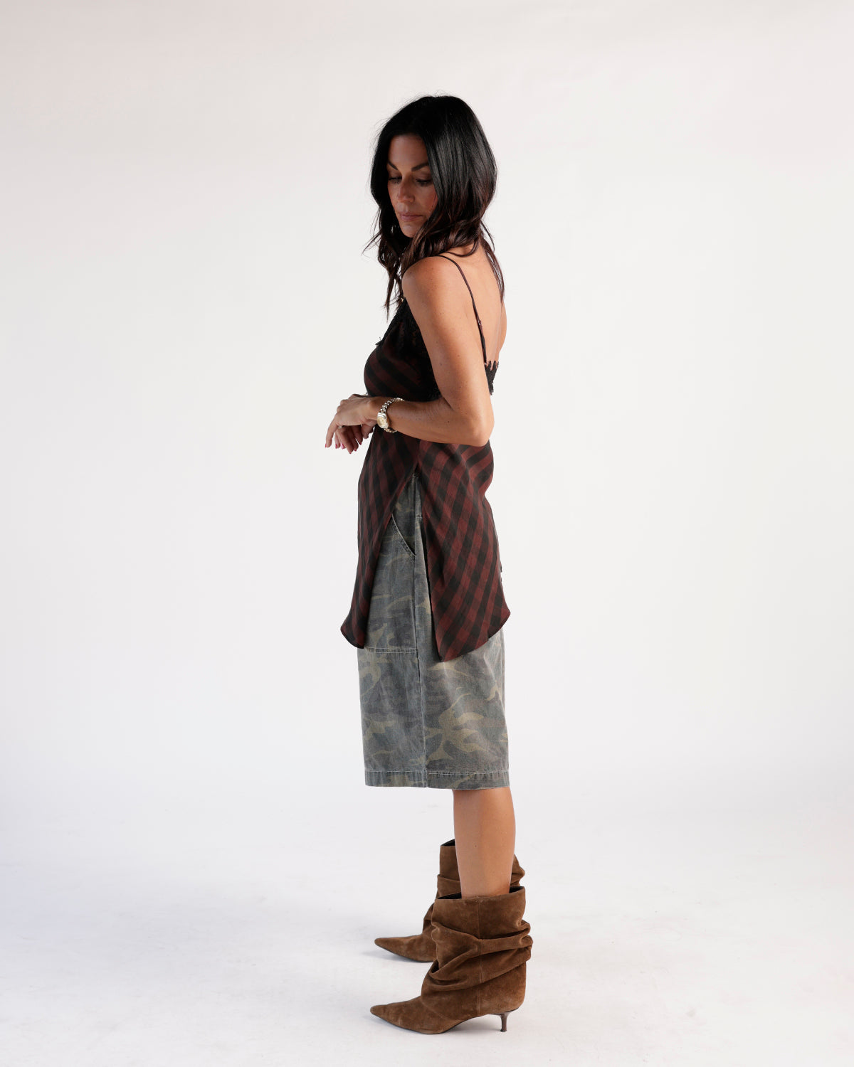 Olive camo cargo shorts, knee-length, worn with plaid top and brown suede boots