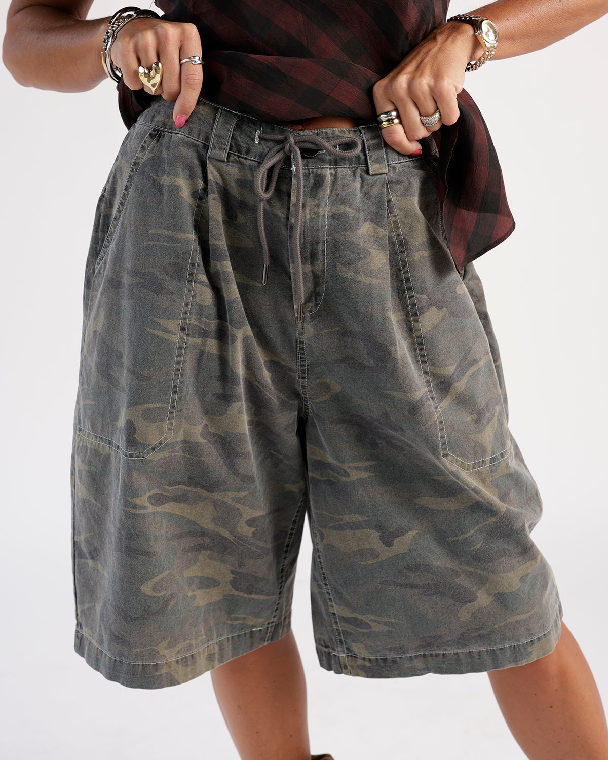 Stay stylish with these camo shorts. Features a faded olive camouflage print, drawstring waistband, and front patch pockets.
