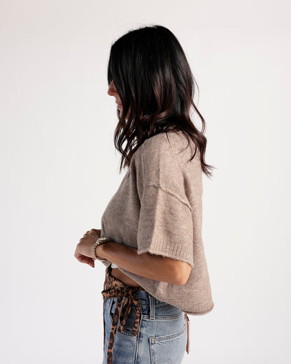 Cropped short-sleeve knit sweater in taupe, worn with light wash jeans and leopard belt