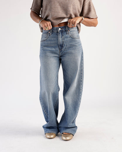Medium wash loose-fit wide-leg jeans with faded detailing and five-pocket styling