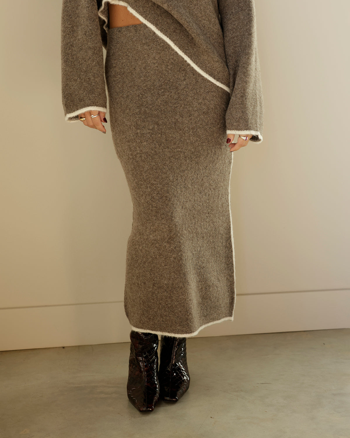 brown wool skirt on women with white trim wearing boots and matching sweater top