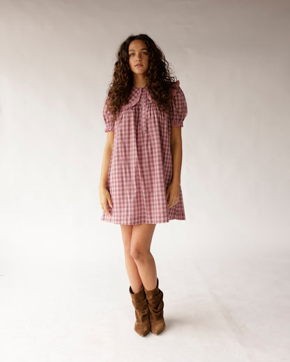 Pink gingham mini dress with puff sleeves, ruffle collar, and button placket