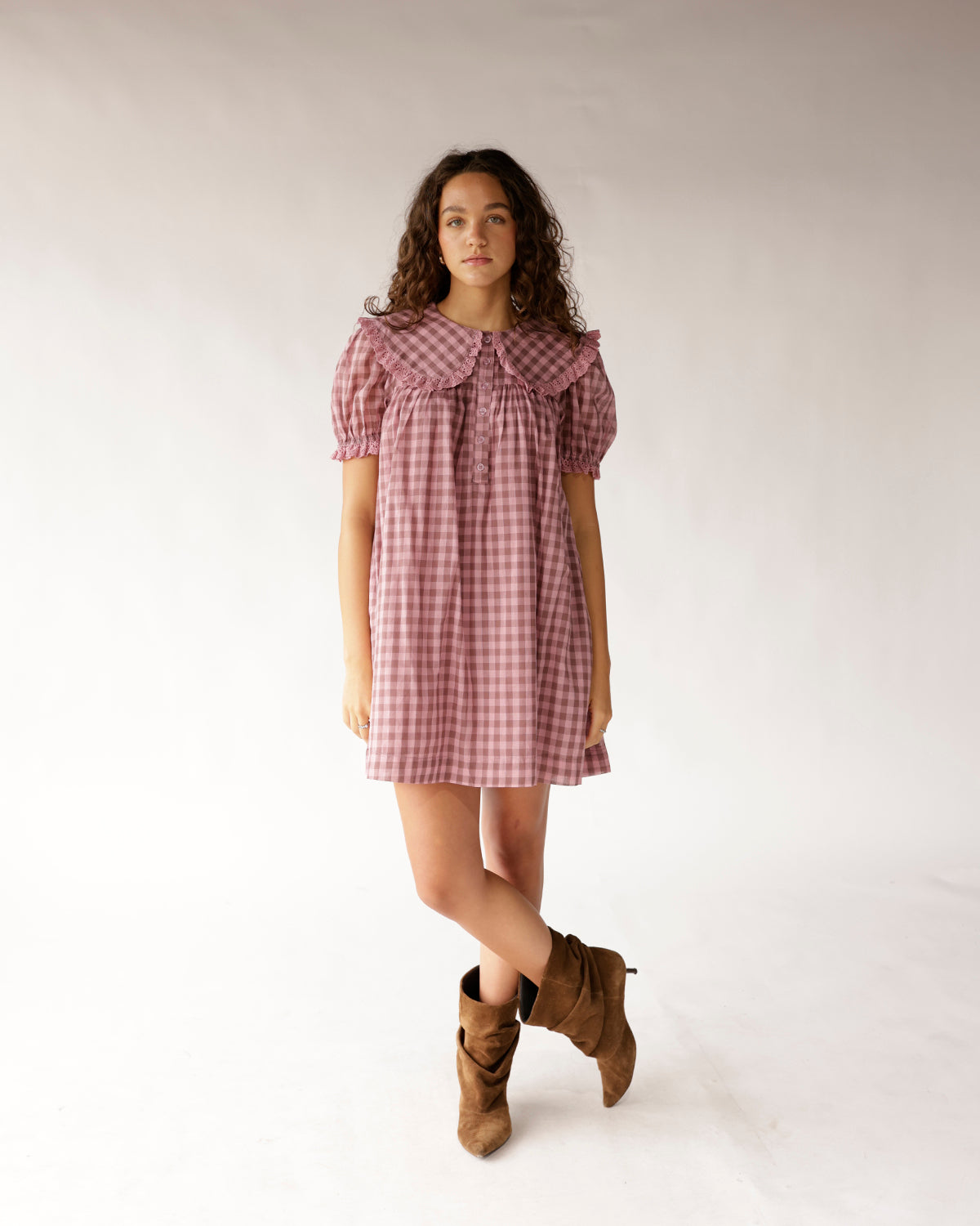 Pink gingham mini dress with oversized collar, puff sleeves, and button front