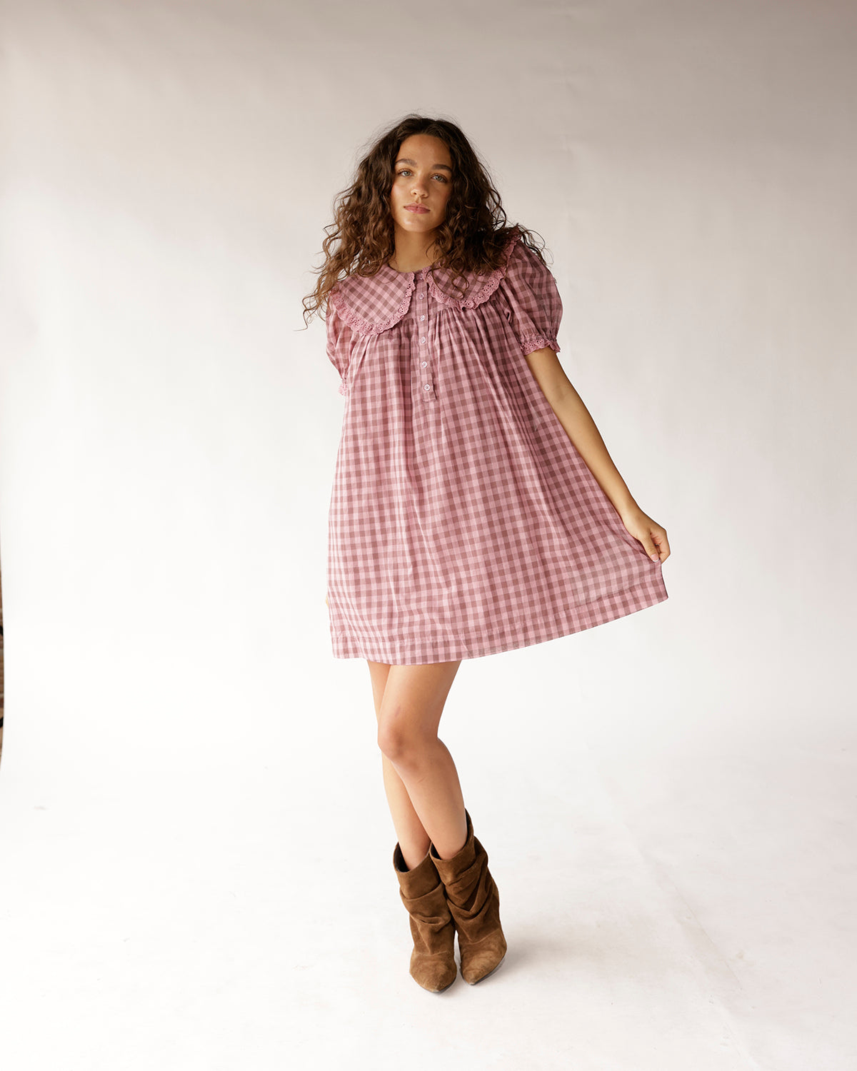 Women's pink gingham midi dress with oversized peter pan collar, eyelet lace trim, and puffed short sleeves. Perfect for warm-weather occasions.