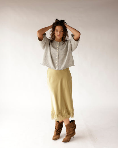 Gray short-sleeve button-front cropped knit sweater with round neck and pearl buttons