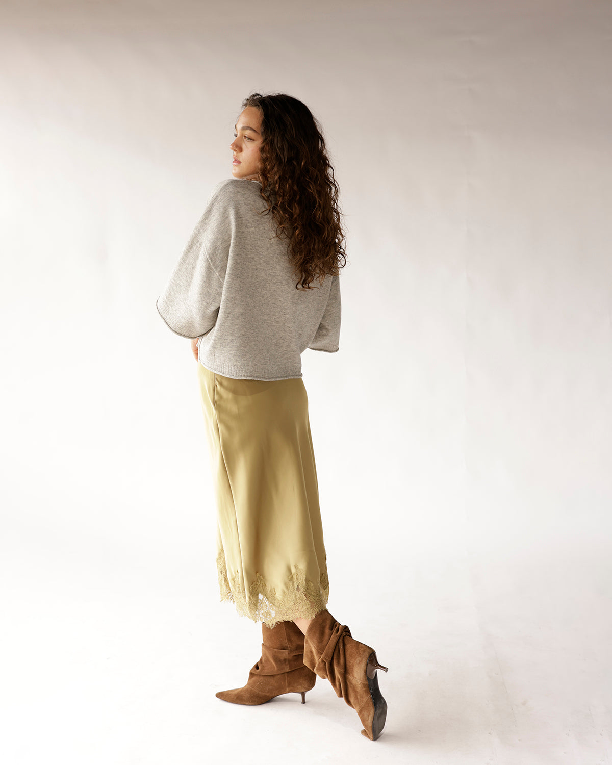 Gray oversized button-up knit sweater with wide sleeves, styled with olive midi skirt