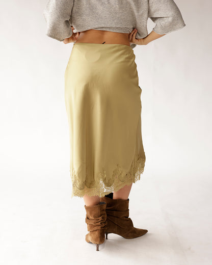 Olive green satin midi skirt with lace hem trim, styled with brown suede boots