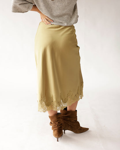 Olive satin midi skirt with lace hem trim, styled with brown suede boots