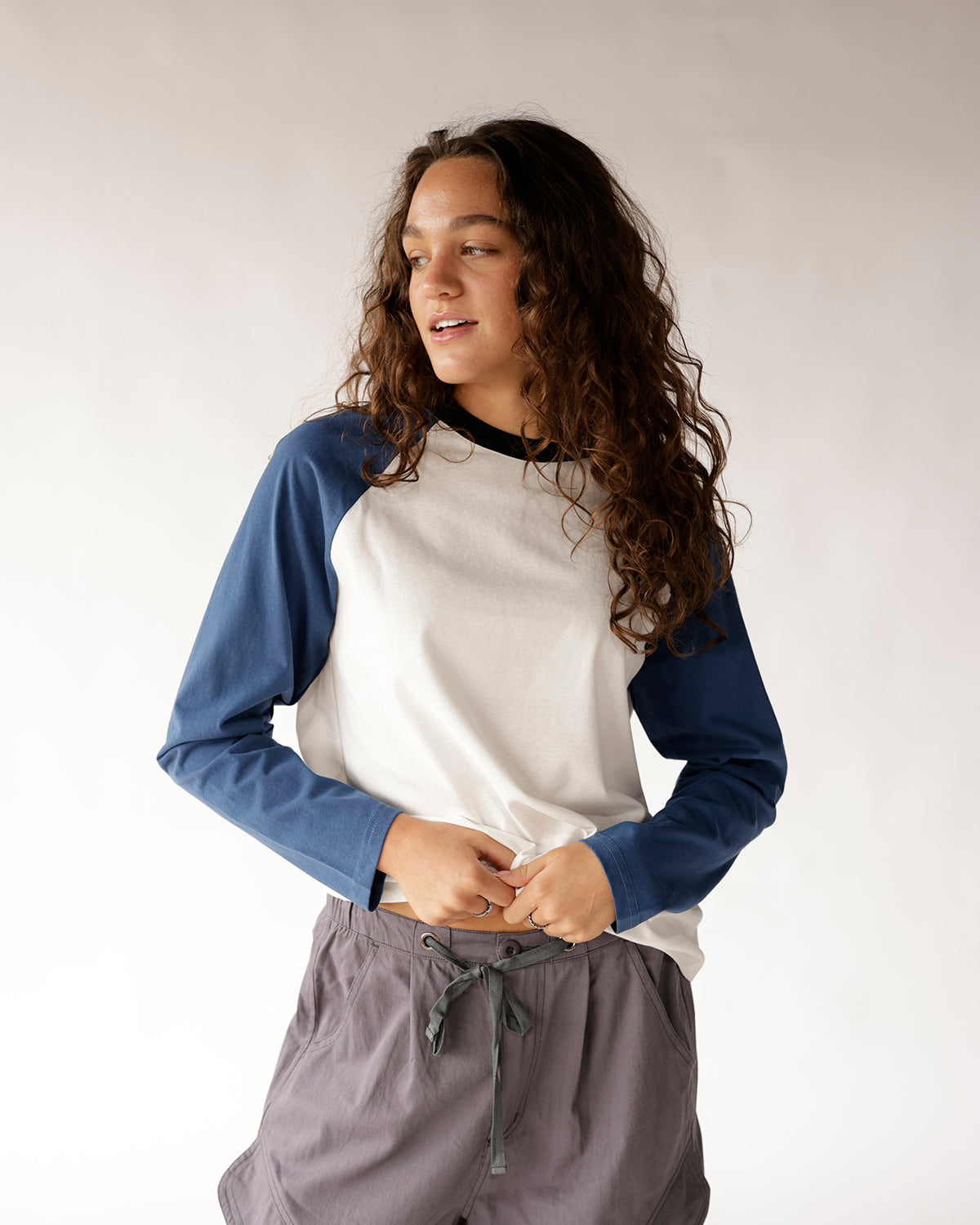 White and blue colorblock raglan long sleeve shirt with black crew neck
