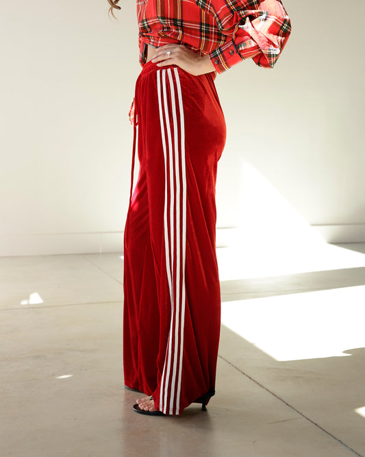 red track pants with a red plaid shirt women in heels 
