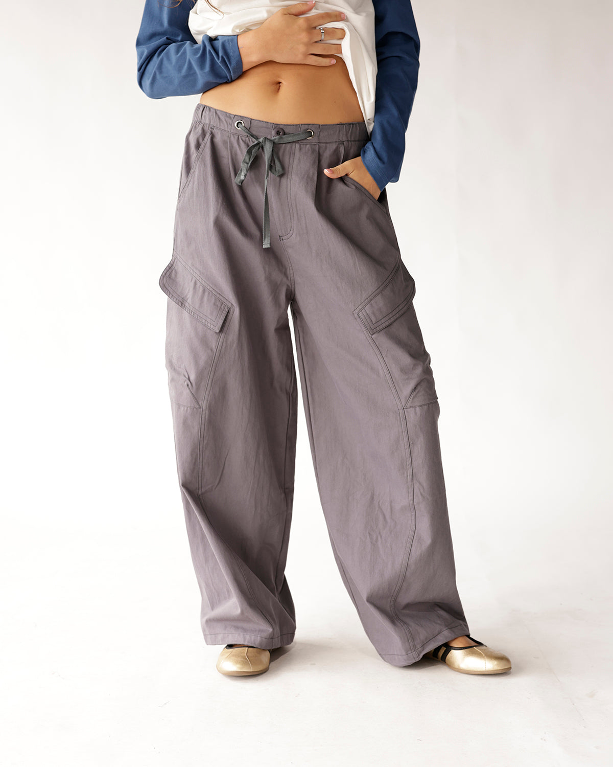 Gray wide-leg cargo pants with drawstring waist and side flap pockets