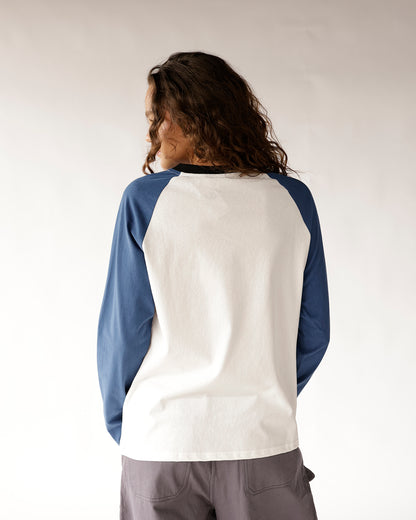 White raglan long-sleeve shirt with blue sleeves and black collar, back view