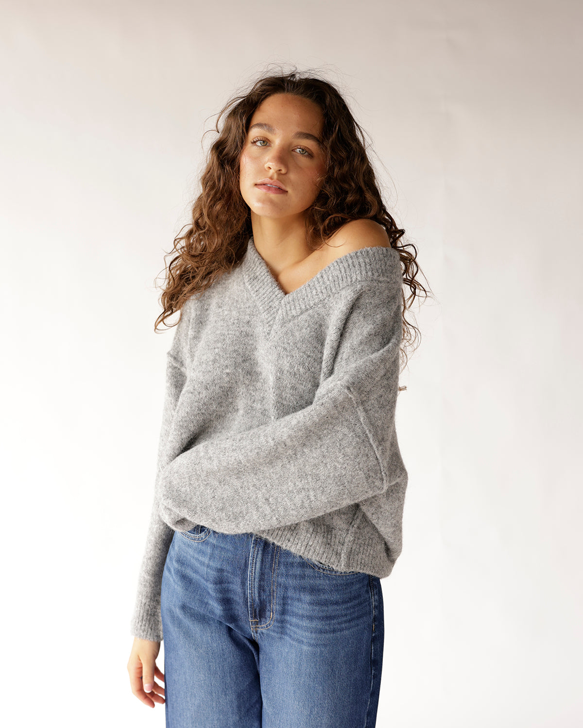 Effortlessly stylish, our Cozy State of Mind Sweater is a versatile piece, perfect for layering or standalone wear. Relaxed fit, V-neck, soft gray knit.