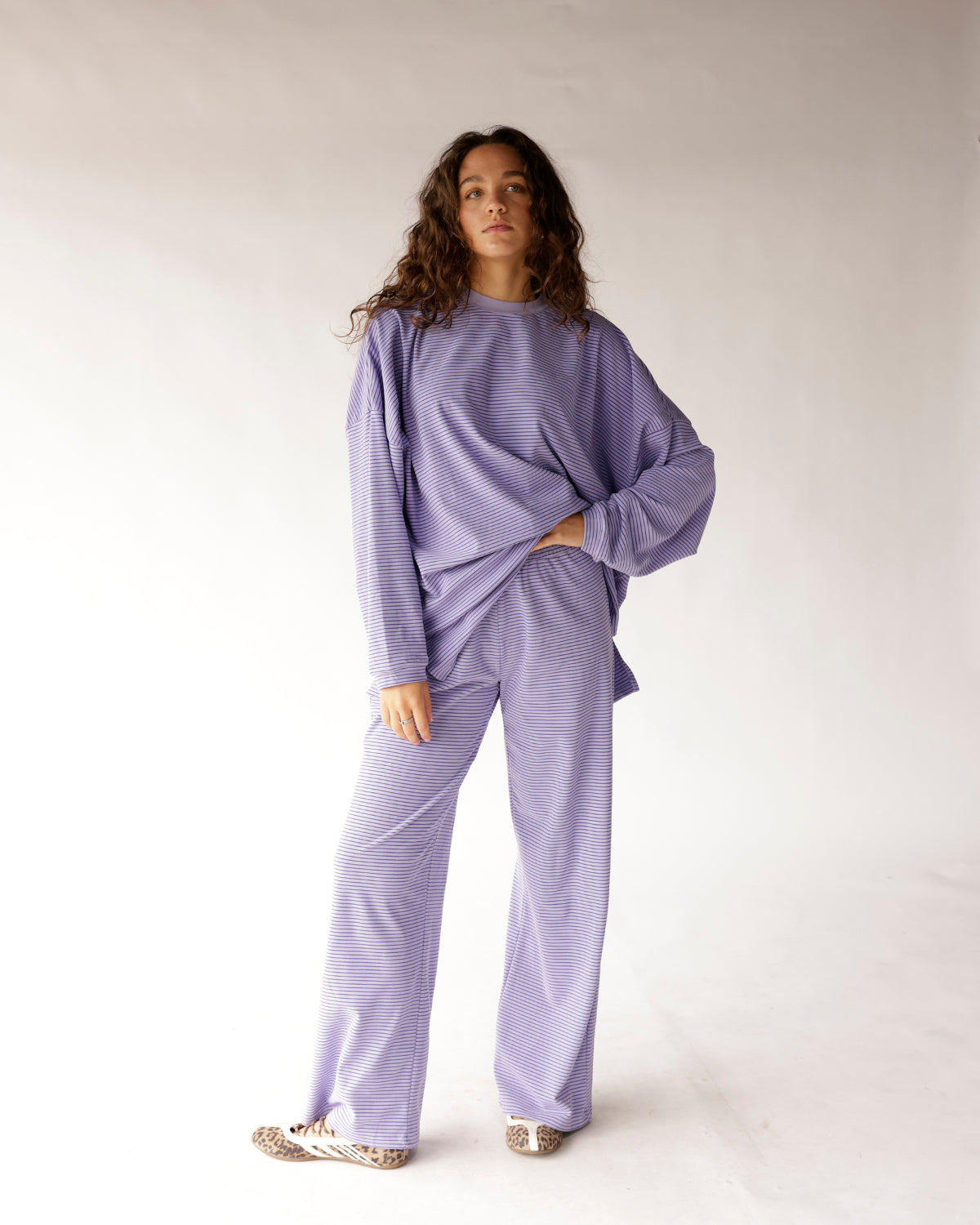 Relax in style with these lavender and dark purple striped wide-leg pants featuring a smocked elastic waistband, flowy silhouette, and soft, comfortable fit. Perfect for pairing with the matching top or your favorite basics for an effortlessly chic everyday look.