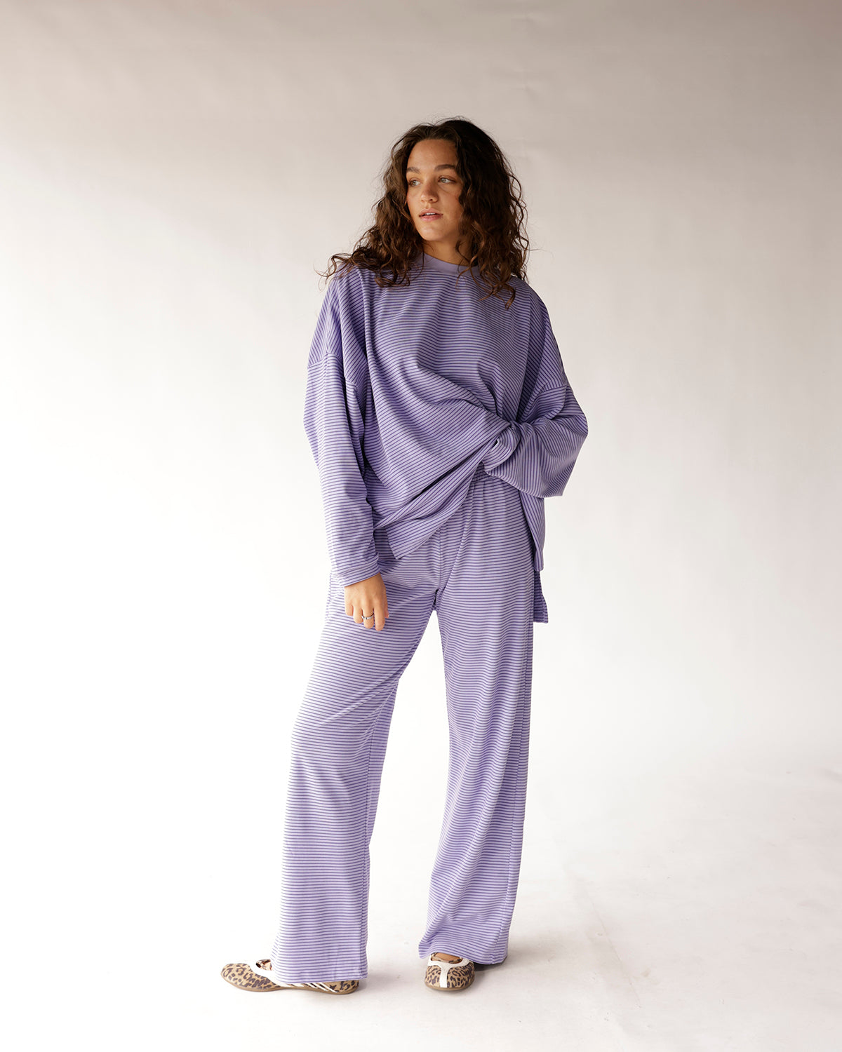 Oversized lavender striped long-sleeve top with relaxed fit and side twist detail