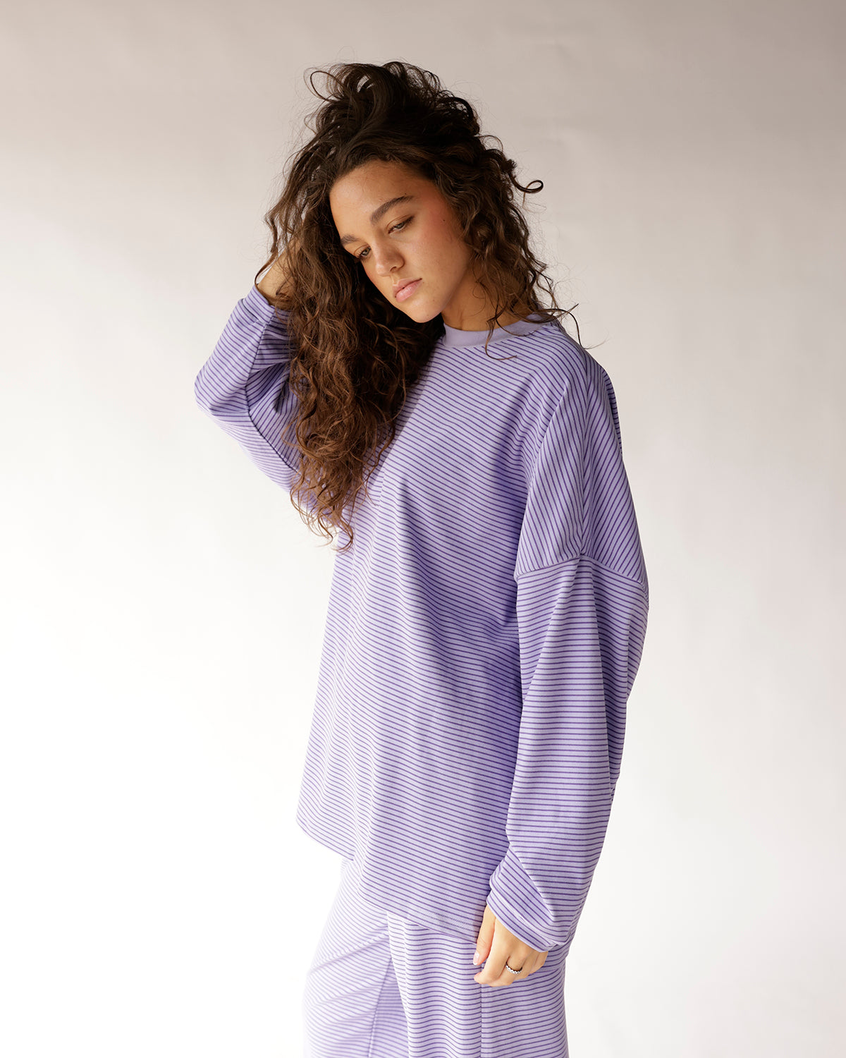Oversized lavender striped long sleeve top with relaxed fit and crew neck
