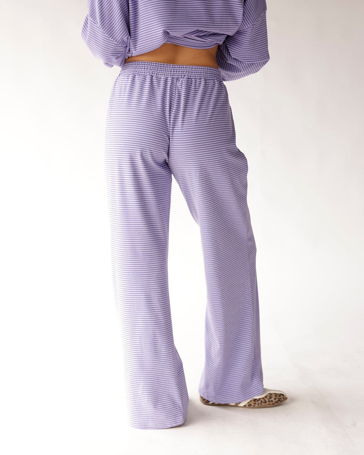 Lavender striped wide-leg lounge pants with elastic waistband, back view